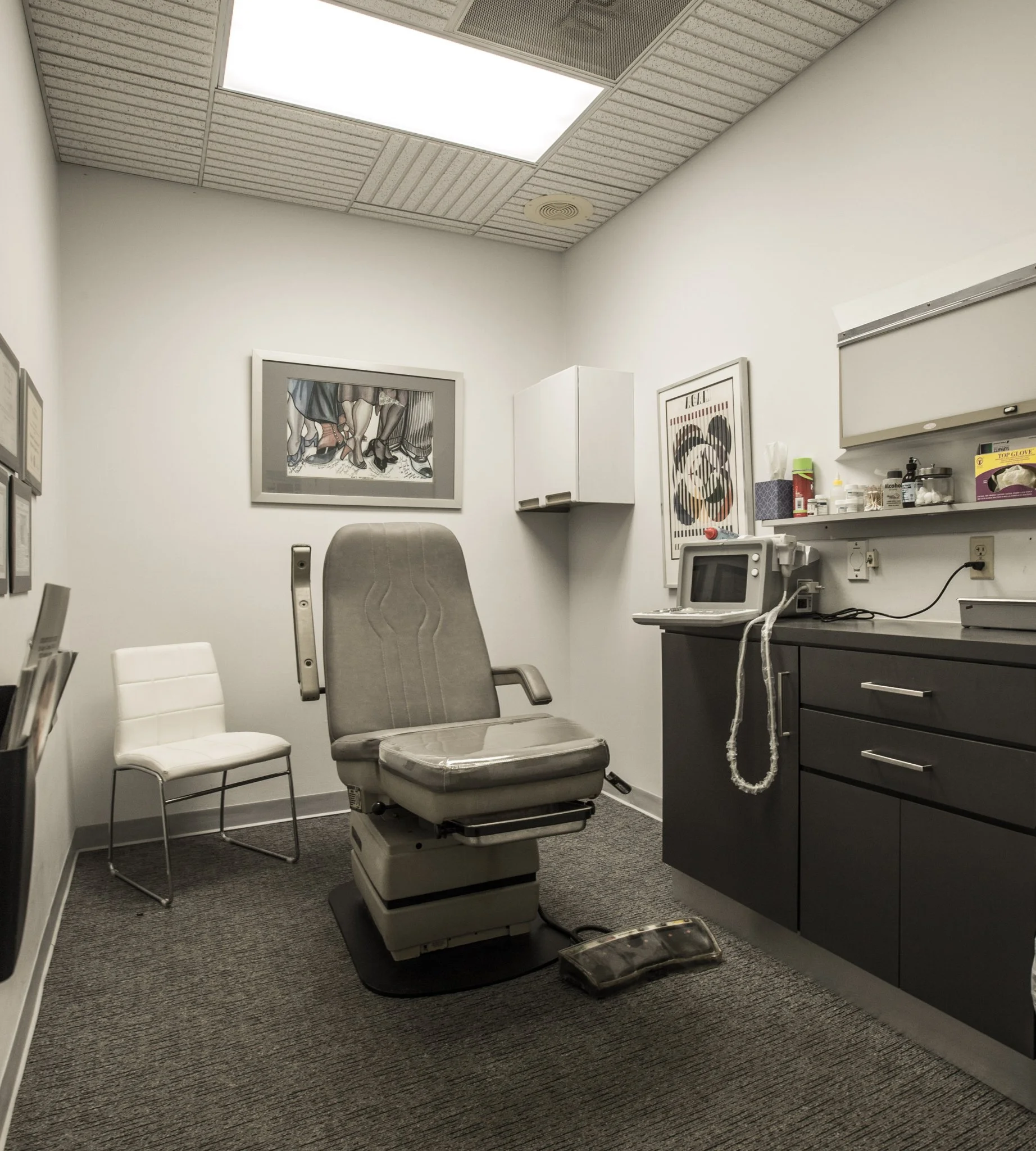 Dr Curson Podiatry Office examination room with podiatry chair, computer workstation, and medical equipment in Surfside, FL